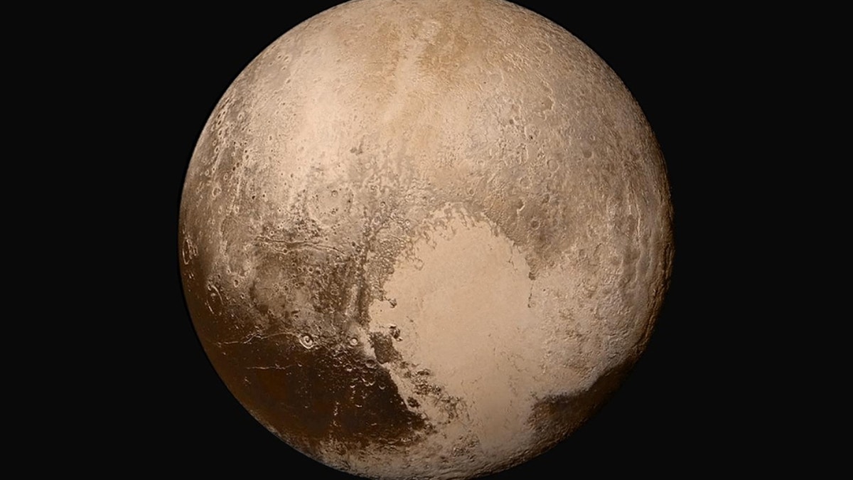 Four images from NASA’s New Horizons’ Long Range Reconnaissance Imager (LORRI) were combined with color data from the Ralph instrument to create this global view of Pluto. Credit: NASA/Johns Hopkins University Applied Physics Laboratory/Southwest Research Institute.