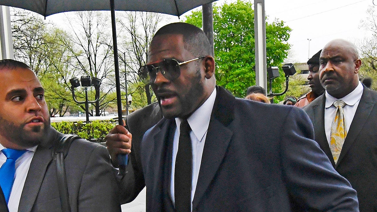 Musician R. Kelly, center, arrives at the Leighton Criminal Court building for a hearing Tuesday, May 7, 2019, in Chicago. (AP Photo/Matt Marton)
