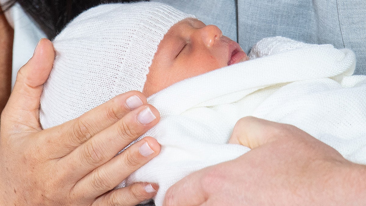 The elusive Baby Sussex made his debut at Windsor Castle with parents Meghan Markle and Prince Harry. Duchess Meghan and the spare heir are yet to reveal their son's name. TOPSHOT - Britain's Prince Harry, Duke of Sussex (R), and his wife Meghan, Duchess of Sussex, pose for a photo with their newborn baby son in St George's Hall at Windsor Castle in Windsor, west of London on May 8, 2019. (Photo by Dominic Lipinski / POOL / AFP)        (Photo credit should read DOMINIC LIPINSKI/AFP/Getty Images)