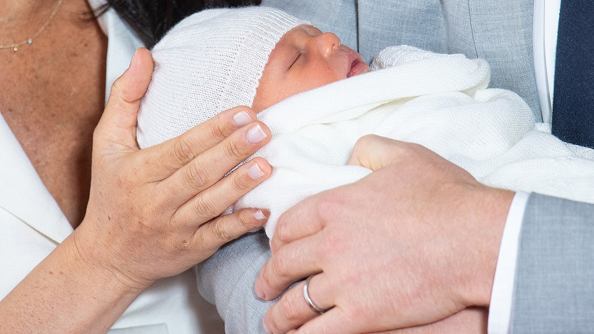 Britain's Prince Harry, Duke of Sussex (R), and his wife Meghan, Duchess of Sussex, pose for a photo with their newborn baby son in St George's Hall at Windsor Castle in Windsor, west of London on May 8, 2019. (Photo by Dominic Lipinski / POOL / AFP) (Photo credit should read DOMINIC LIPINSKI/AFP/Getty Images)