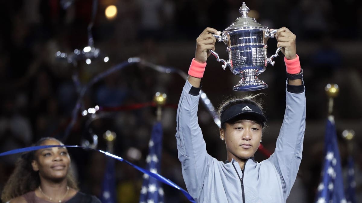 Naomi Osaka, of Japan, holds the trophy after defeating Serena Williams in the women's final of the U.S. Open tennis tournament, Saturday, Sept. 8, 2018, in New York. (Associated Press)