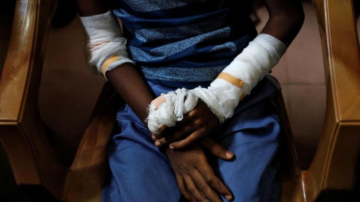 An injured member of Zion Church, which was bombed on Easter Sunday, cries as she prays at a community hall on May 5, 2019.