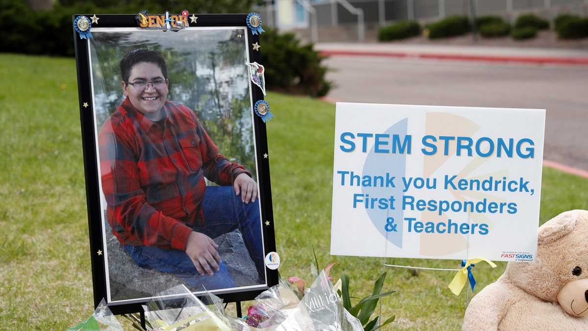 A photograph of student Kendrick Castillo stands amid a display of tributes outside the STEM School Highlands Ranch a week after the attack on the school that left Castillo dead and others injured, Tuesday, May 14, 2019, in Highlands Ranch, Colo.