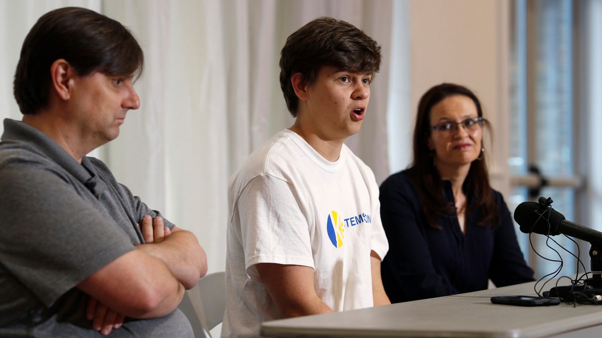 Joshua Jones, center, who was wounded while trying to stop a gunman involved in the attack on the STEM School Highlands Ranch last week, speaks during a news conference as his father, David, left, and mother, Lorie, listen.