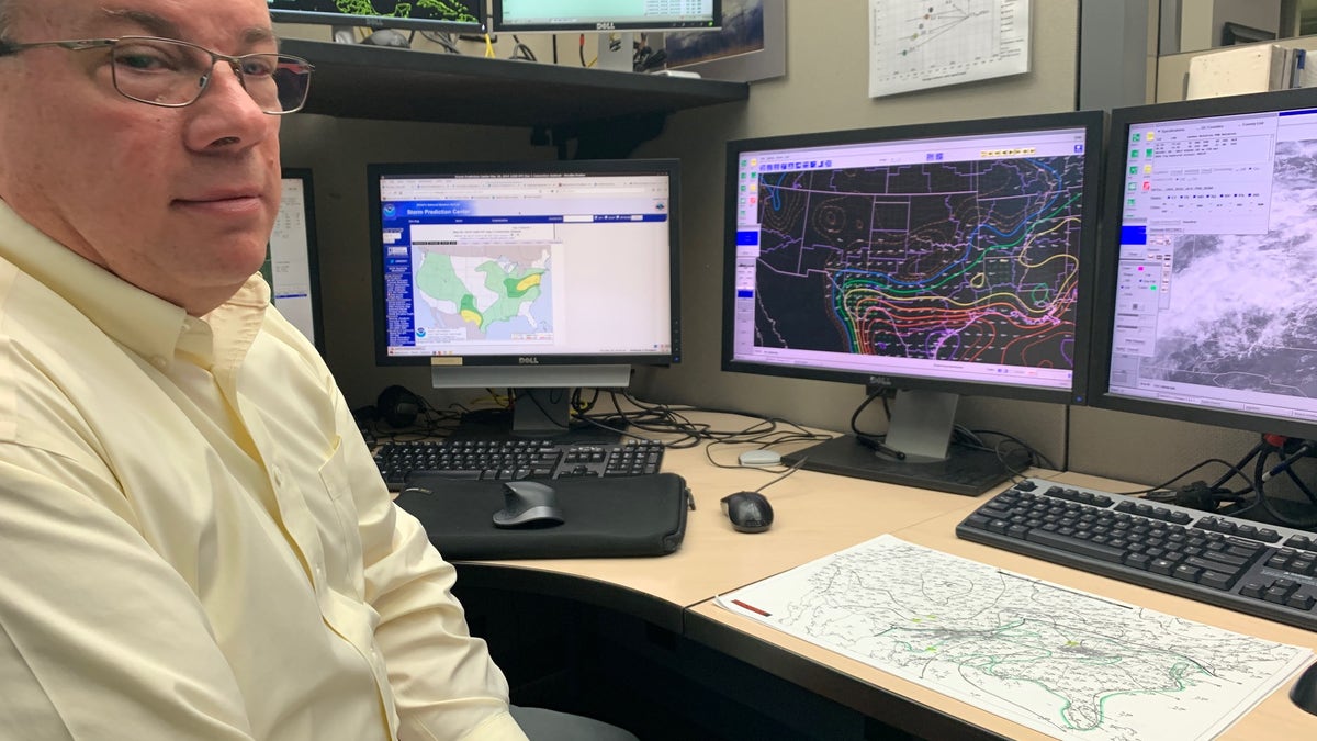 William Bunting, Chief of Forecast Operations at the Storm Prediction Center in Norman, Okla. sits beside a hand-marked weather map