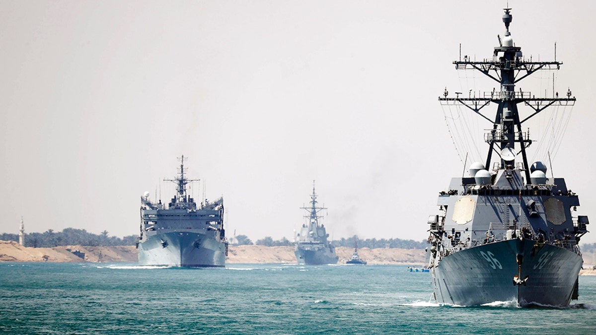 In this photo provided by the U.S. Navy, the Abraham Lincoln Carrier Strike Group transits the Suez Canal, Thursday, May 9, 2019.