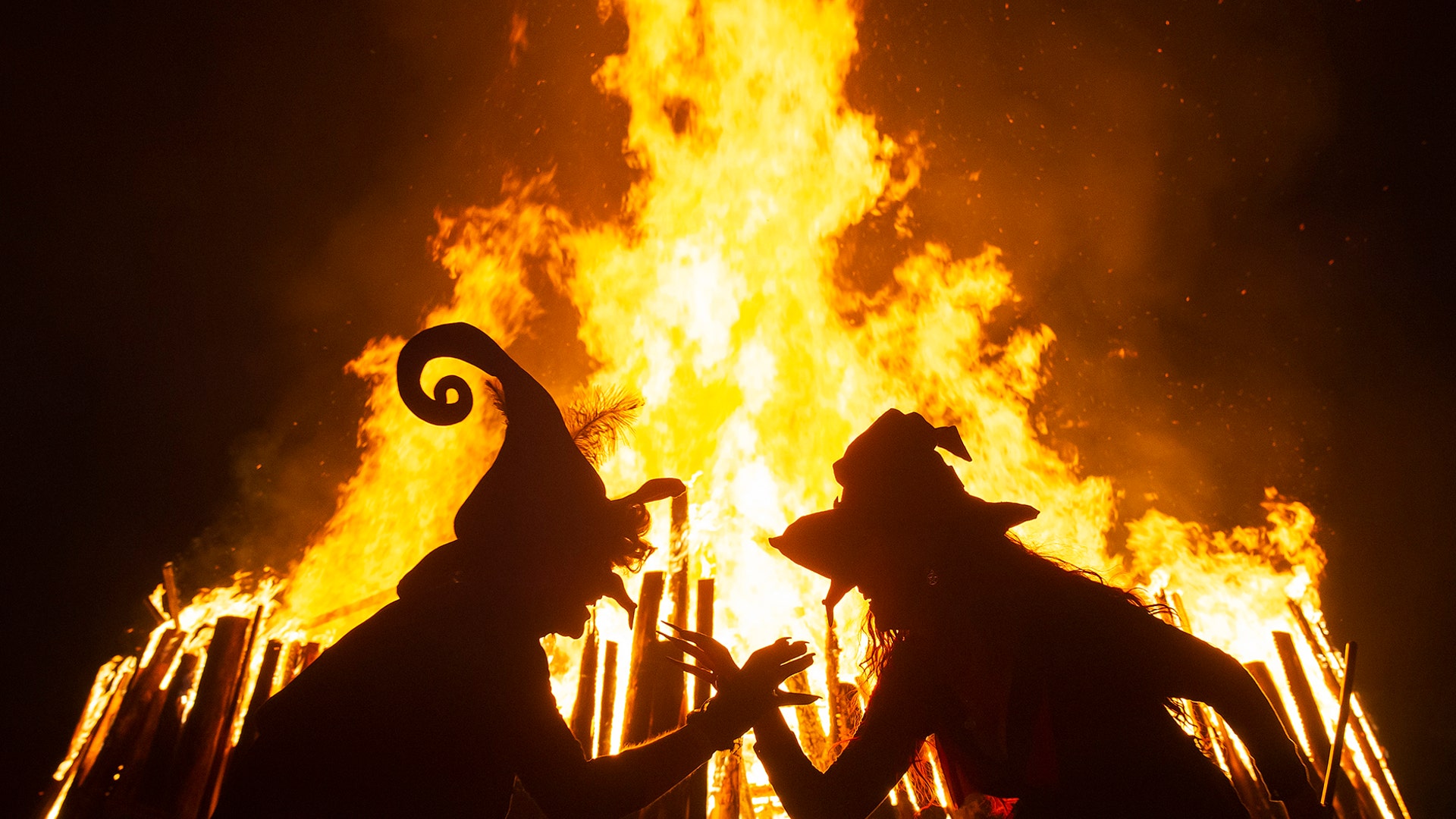Women dressed as witches dance in front of the fire during the Walpurgis night in Erfurt, Germany, April 30, 2019.