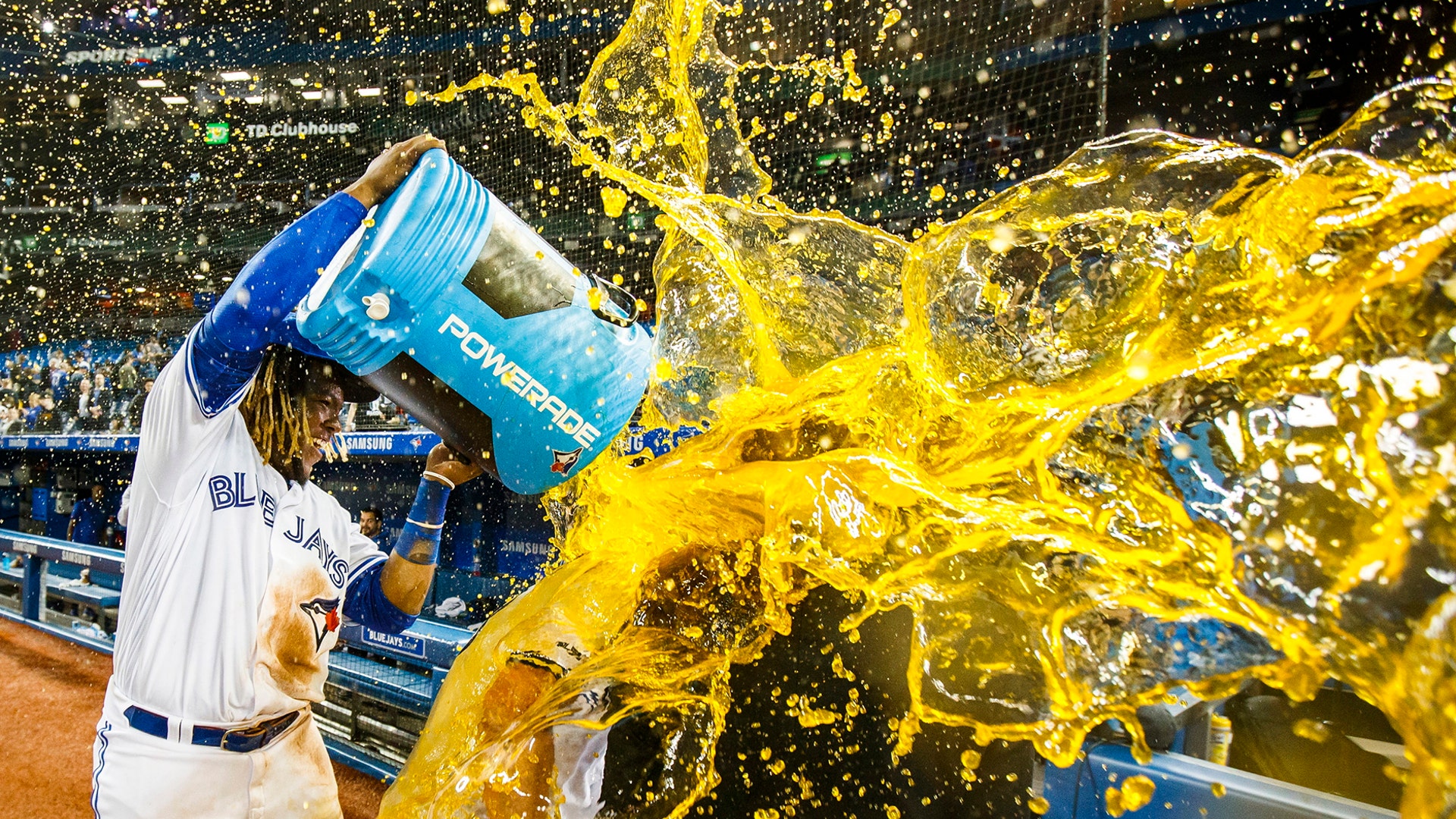 Toronto Blue Jays' Vladimir Guerrero Jr., douses teammate Brandon Drury after Drury hit a walk-off home run to defeat the Oakland Athletics in Toronto, April 26, 2019.