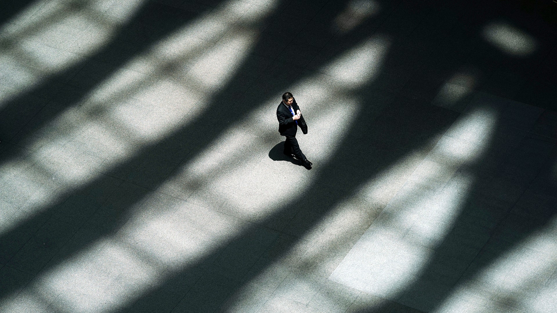 A man walks in the shade of a building in Tokyo, May 10, 2019. 