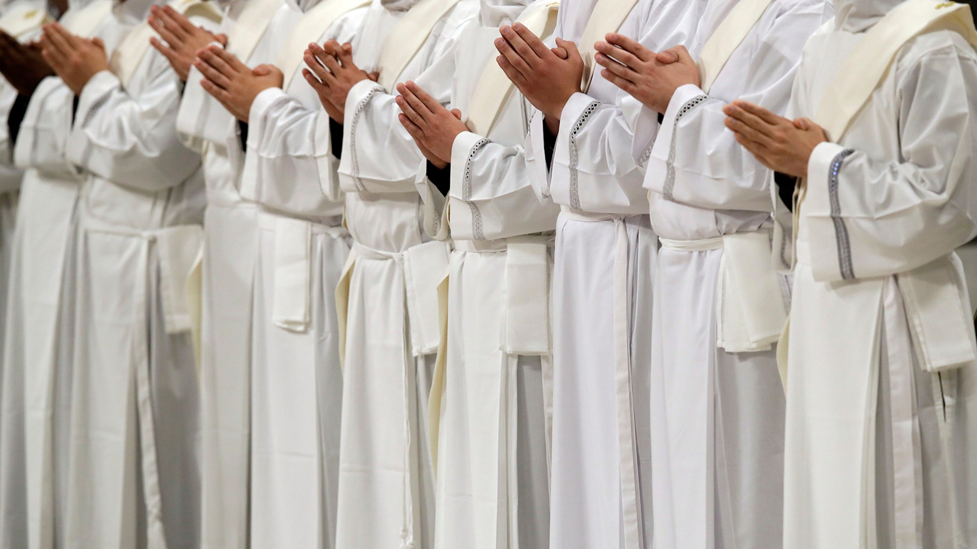 Newly ordained priests pray during a ceremony led by Pope Francis in St. Peter's Basilica at the Vatican, May 12, 2019. 