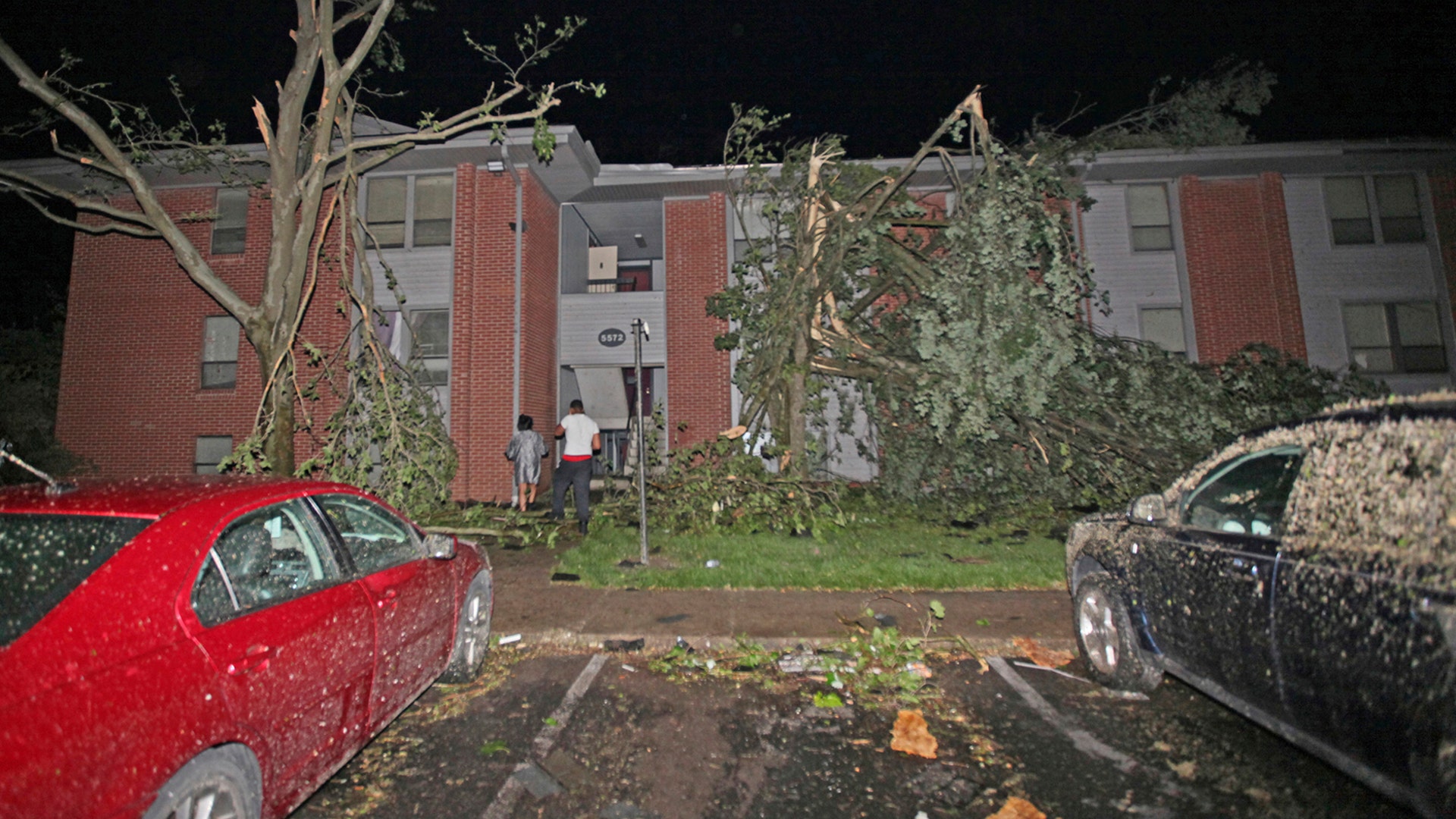 Residents walk toward their Westbrooke Village Apartment building that was heavily damaged by a tornado in Dayton, Ohio, May 28, 2019.