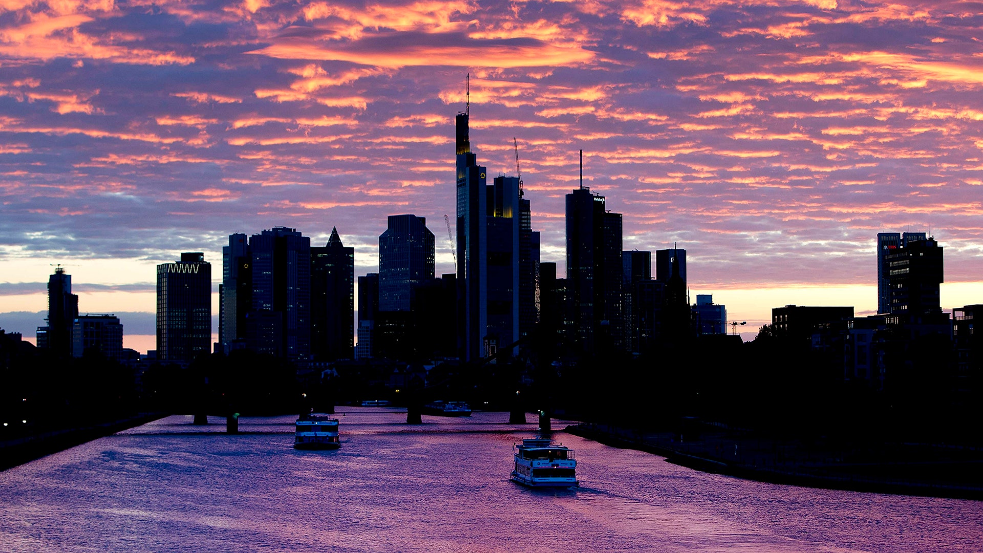 Ships pass by on the river Main at sunset in Frankfurt, Germany, May 15, 2019.