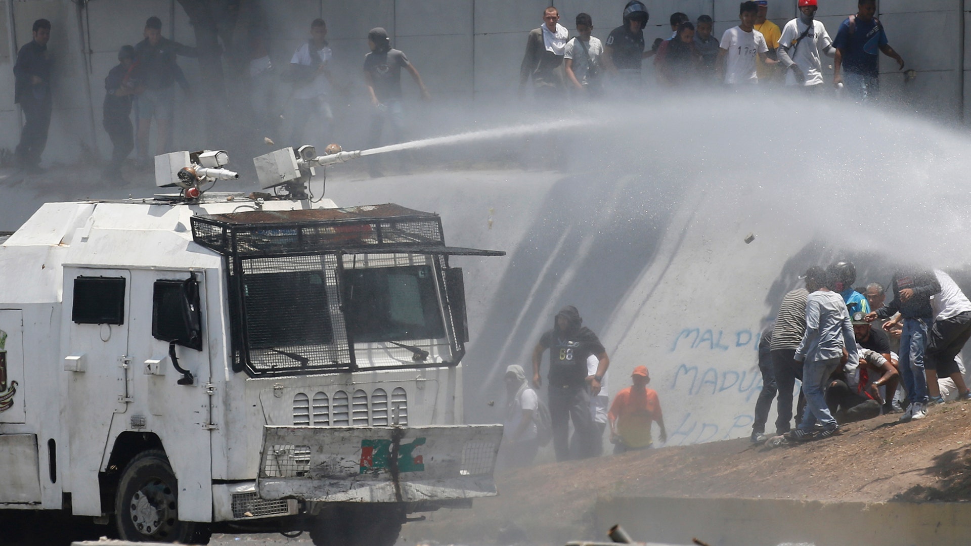 A Bolivarian National Guard water canon sprays opponents of Venezuela's President Nicolas Maduro during an attempted military uprising and anti-government protests in Caracas, Venezuela, April 30, 2019.