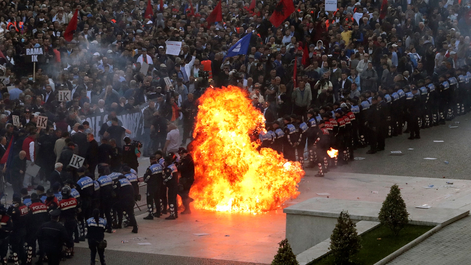 A petrol bomb explodes after being thrown toward a police line blocking protesters taking part in an anti-government rally in Tirana, May 11, 2019. 