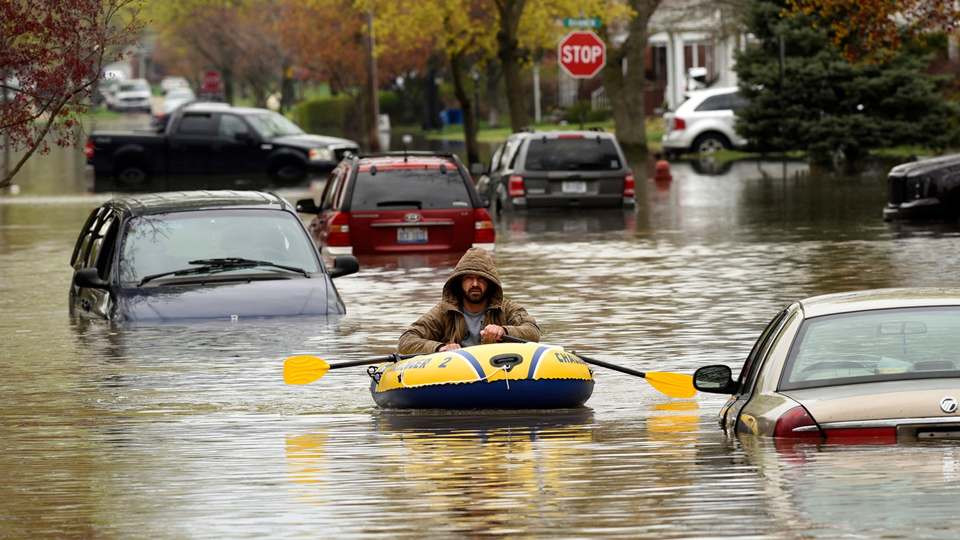 A Hanover Street resident surveys the damage along Currier Street following flooding in Dearborn Heights, Michigan, May 1, 2019.