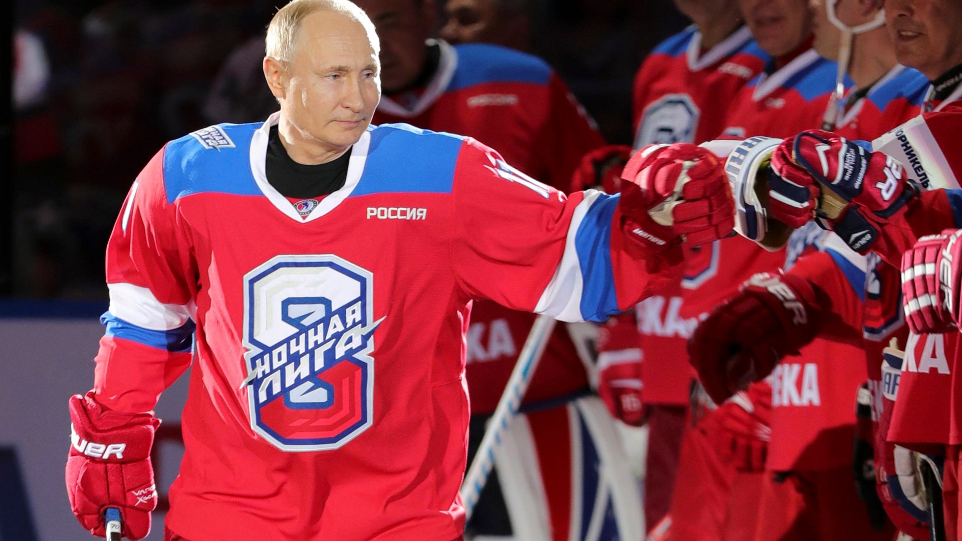 Russian President Vladimir Putin greets his teammates prior to a hockey match at the Bolshoi Arena in the Black Sea resort of Sochi, Russia, May 10, 2019.