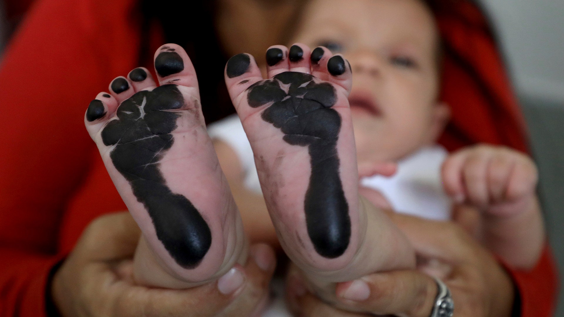 Arelys Pulido holds her 2-month-old daughter Zuleidys Antonella Primera after she had her feet prints taken for her birth certificate at the Erazmo Meoz hospital in Cucuta, on Colombia's border with Venezuela, May 2, 2019. 