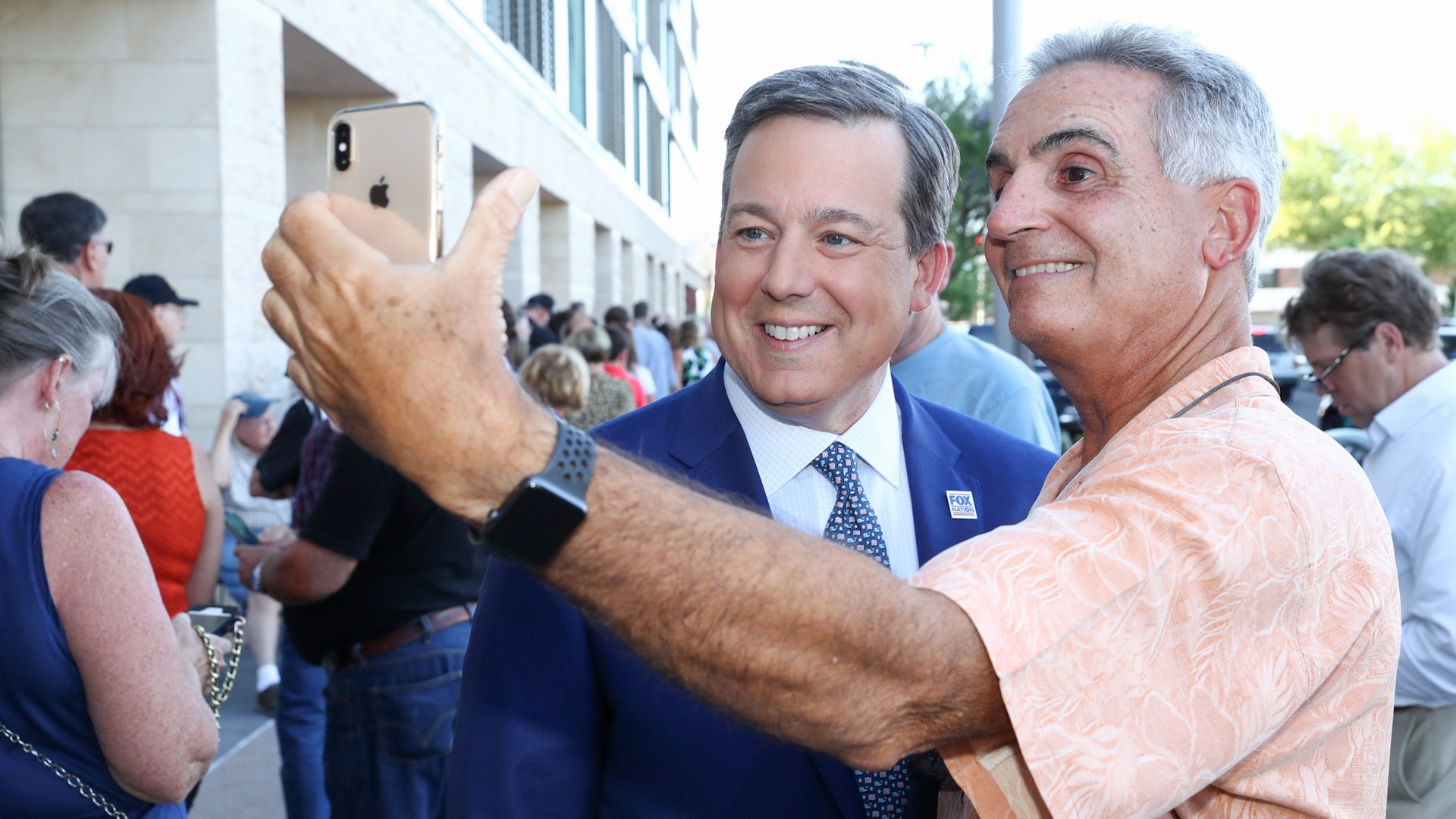 A fan takes a selfie picture with Ed Henry at Fox Nation's inaugural fan summit.