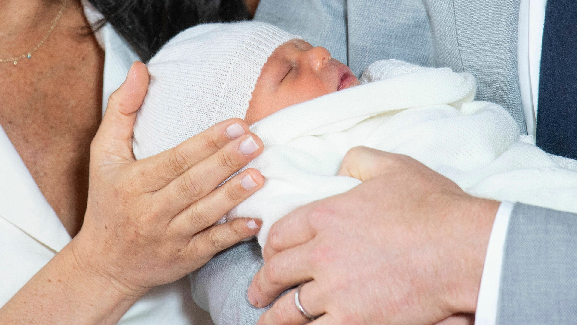 Britain's Prince Harry and Meghan, Duchess of Sussex, hold their newborn son, Archie, in St George's Hall at Windsor Castle, Windsor, May 8, 2019. 