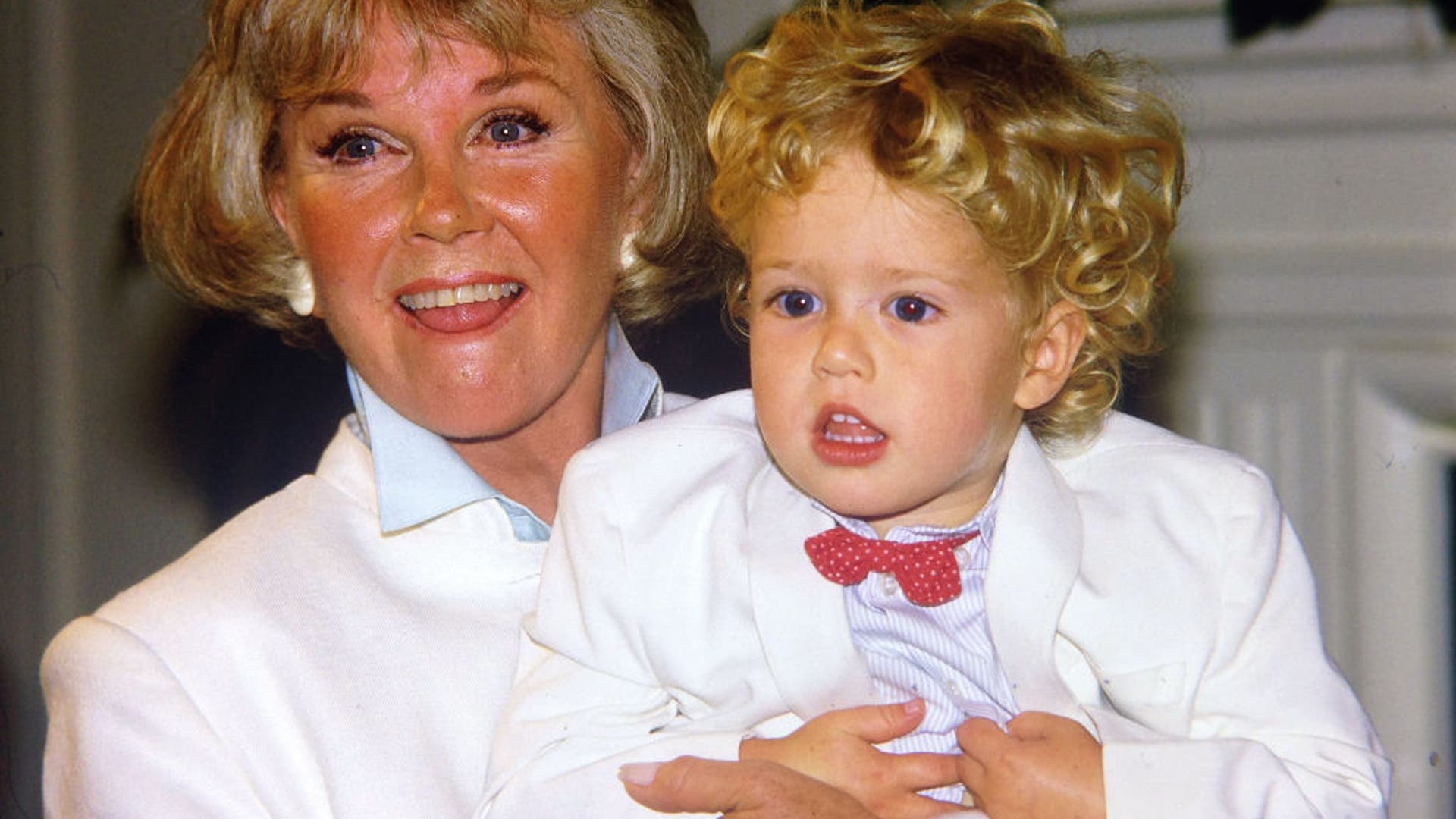 Doris Day poses with her grandson, Ryan Melcher (the son of her only child Terry Melcher) at a press conference at the hotel she owns in Carmel, Calif., in July 1985.