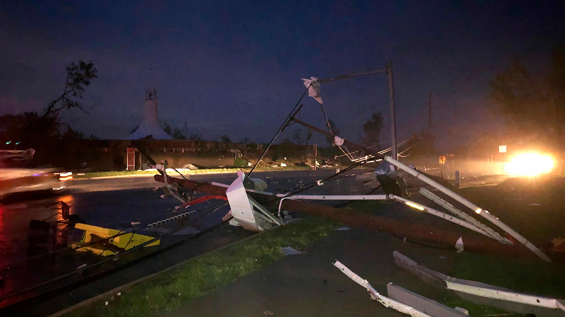 Downed power lines stretch into a street in Jefferson City. (AP Photo/David A. Lieb)