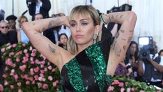 Miley Cyrus poses topless as she gets ready for the 2019 Met Gala