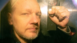 Julian Assange refuses extradition to US, says he won't 'surrender' during British court appearance via video link