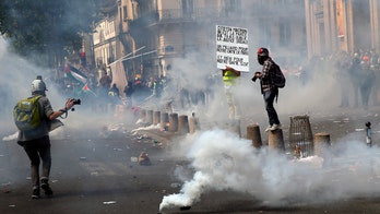 May Day rallies descend into violent clashes with police in Paris as demonstrations are held around the world
