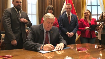 Missouri governor signs bill banning abortions at 8 weeks