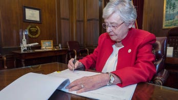 Alabama governor signs restrictive abortion bill into law as ACLU vows to sue