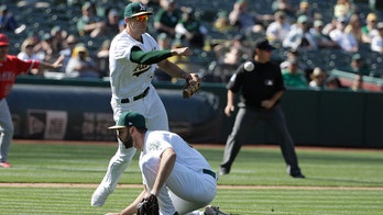 Fan tries his hardest to snag foul ball during Oakland Athletics game