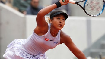 Osaka hangs tough at French Open; Williams, Djokovic win