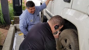 Chick-fil-A employees change customer's flat tire at the drive-thru
