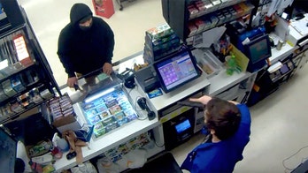 Hatchet-wielding thief backs down when store clerk pulls out gun - but firearm costs employee his job