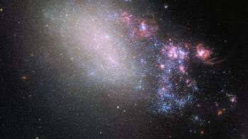 Titanic galactic collision left one galaxy twisted and warped, Hubble reveals