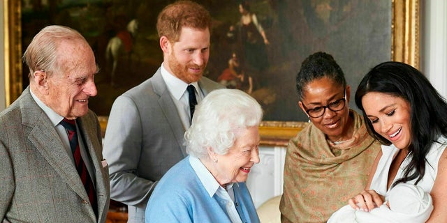 Prince Harry and Meghan, Duchess of Sussex, joined by her mother Doria Ragland, show their new son to Queen Elizabeth II and Prince Philip at Windsor Castle. This image was made available by SussexRoyal on Wednesday, May 8, 2019. 