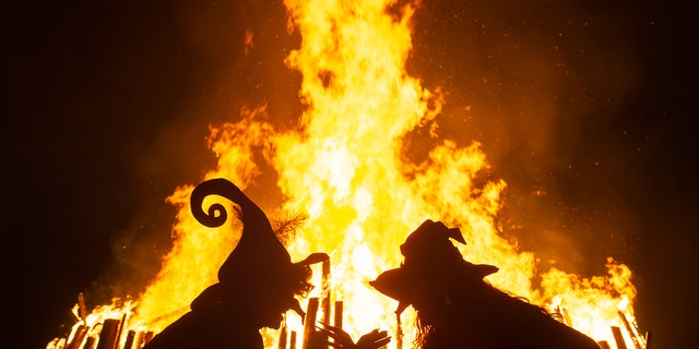 Women dressed as witches dance in front of the fire during the Walpurgis night in Erfurt, Germany, Tuesday, April 30, 2019. (Associated Press)