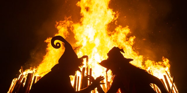 Women dressed as witches dance in front of the fire during the Walpurgis night in Erfurt, Germany, Tuesday, April 30, 2019. (Associated Press)