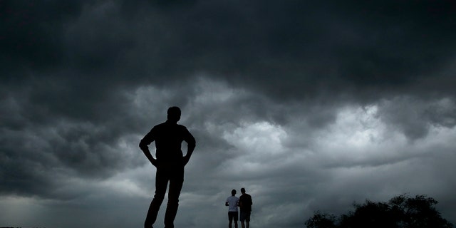 People watch from the Liberty Memorial as a severe storm that dropped several tornadoes earlier approaches downtown Kansas City, Mo., Tuesday, May 28, 2019. (AP Photo/Charlie Riedel)