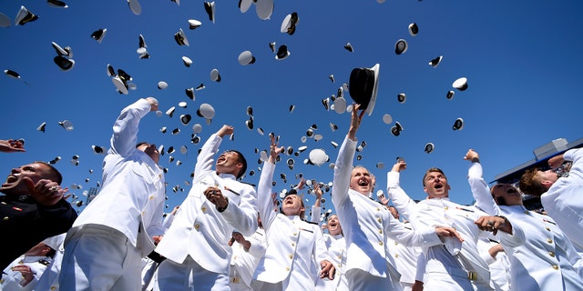 Graduating members of the U.S. Naval Academy celebrate at the end of the academy's graduation and commissioning ceremony, Friday, May 24, 2019, in Annapolis, Md.