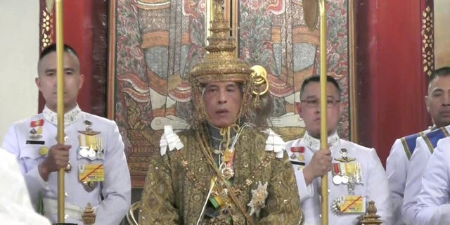 In this image made from the video, Thailand’s King Maha Vajiralongkorn, center, sits on the throne as he is officially crowned king at the Grand Palace, Saturday, May 4, 2019, in Bangkok, Thailand. Saturday began three days of elaborate centuries-old ceremonies for the formal coronation of Vajiralongkorn.