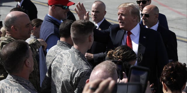 President Donald Trump greets troops after landing at Joint Base Elmendorf-Richardson for a refueling stop en route to Japan Friday, May 24, 2019, in Anchorage. (Associated Press)