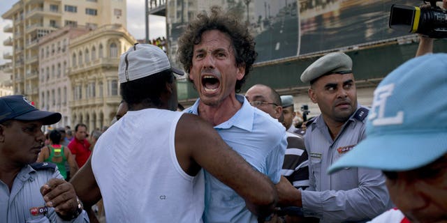 Cuban police detain a gay rights activist taking part in an unauthorized march in Havana, Cuba, Saturday, May 11, 2019. The march was organized largely using Cuba's new mobile internet, with gay-rights activists and groups of friends calling for a march over Facebook and WhatsApp after the government-run gay rights organization canceled a Saturday march.