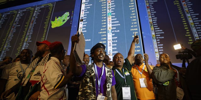 A gathering of representatives of smaller parties take to the stage to protest their claim that the elections were not free or fair, at the Independent Electoral Commission Results Center in Pretoria, South Africa, Thursday, May 9, 2019.