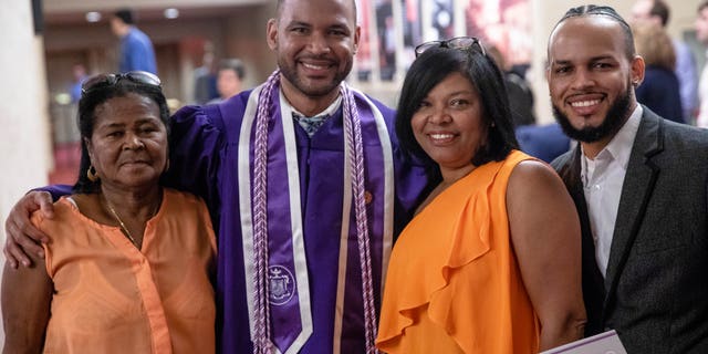 Frank Baez poses with family and friends after his graduation ceremony from the New York University Rory Meyers College of Nursing.