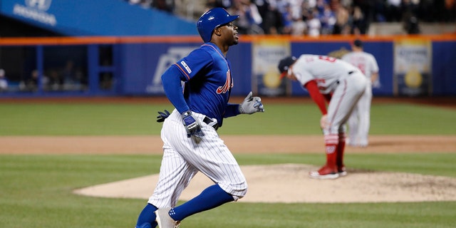 New York Mets' Rajai Davis, left, runs between third and home on his eighth-inning, three-run home run in a team's ball diversion opposite a Washington Nationals, on Wednesday in New York, as Nationals service pitcher Sean Doolittle, right, reacts on a mound. (Associated Press)