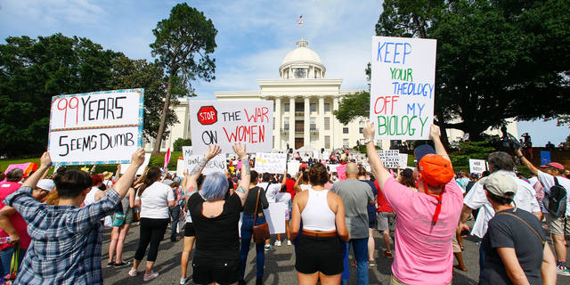 Protesters for women's rights hold a rally on the Alabama Capitol steps to protest a law passed last week making abortion a felony in nearly all cases with no exceptions for cases of rape or incest, Sunday, May 19, 2019, in Montgomery, Ala. (AP Photo/Butch Dill)