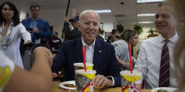 Former vice president and Democratic presidential candidate Joe Biden, center, talks to patrons he makes a visit to King Taco with Los Angeles Mayor Eric Garcetti Wednesday, May 8, 2019, in Los Angeles. (AP Photo/Jae C. Hong)