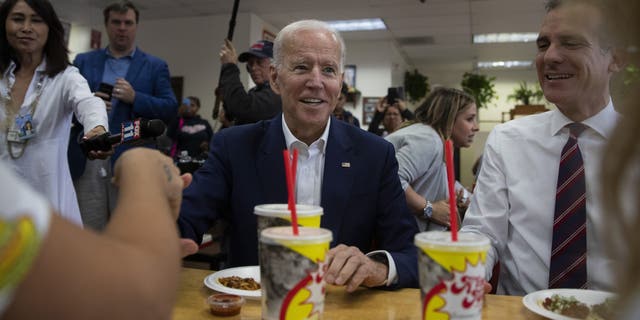 Former vice president and Democratic presidential candidate Joe Biden, center, talks to patrons he makes a visit to King Taco with Los Angeles Mayor Eric Garcetti Wednesday, May 8, 2019, in Los Angeles. (AP Photo/Jae C. Hong)