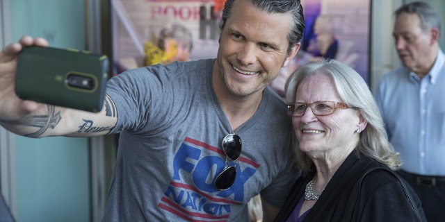 Pete Hegseth takes a picture with a loyal Fox News fan at the Fox Nation summit.